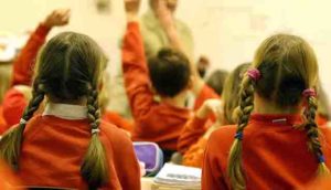 Girls in a primary school classroom teaching.